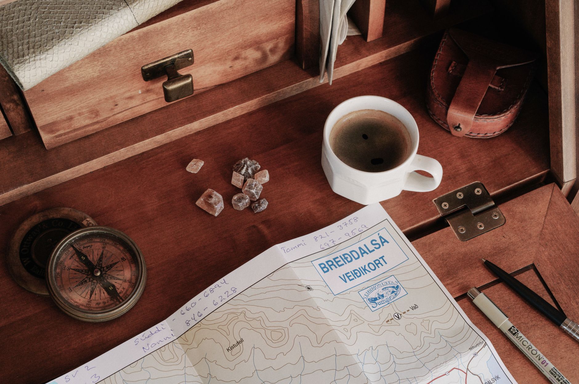 Editorial desk with maps and coffee
